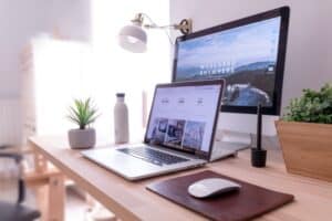 Two desktops with websites showing on them to demonstrate web design on the Small Business Marketing Consultant website