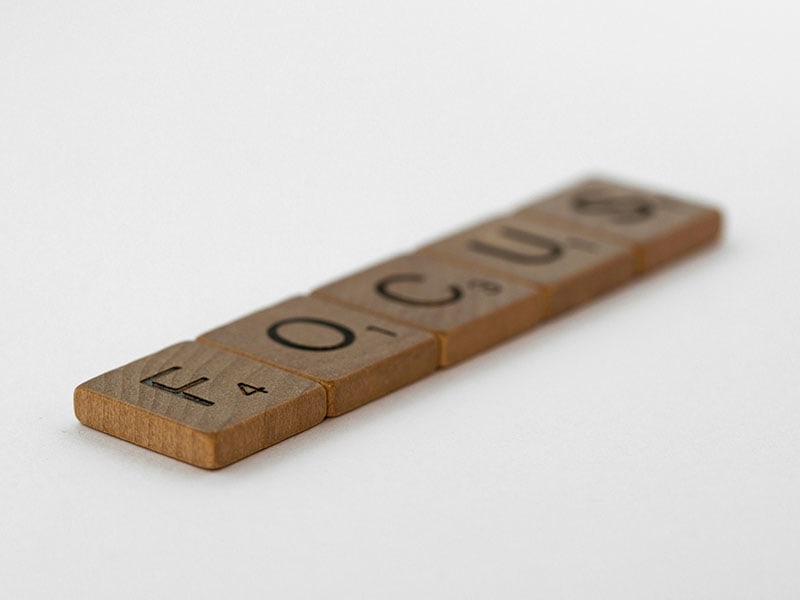 Scrabble letters with the word Focus showing what small business marketing consultants will help business owners to do.