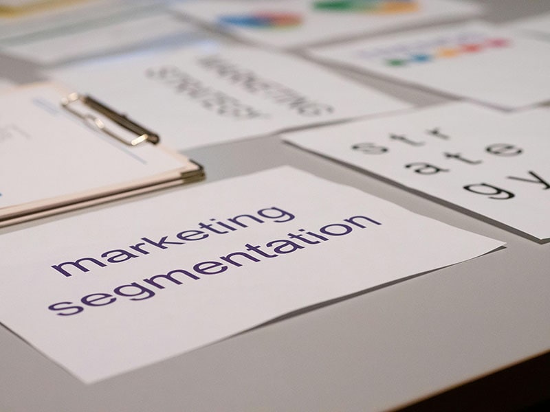 Posters with marketing labels scattered on a table to show small business consulting services.